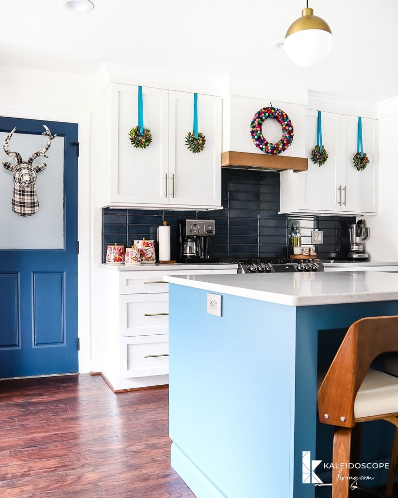 colorful christmas decorations in white and blue kitchen
