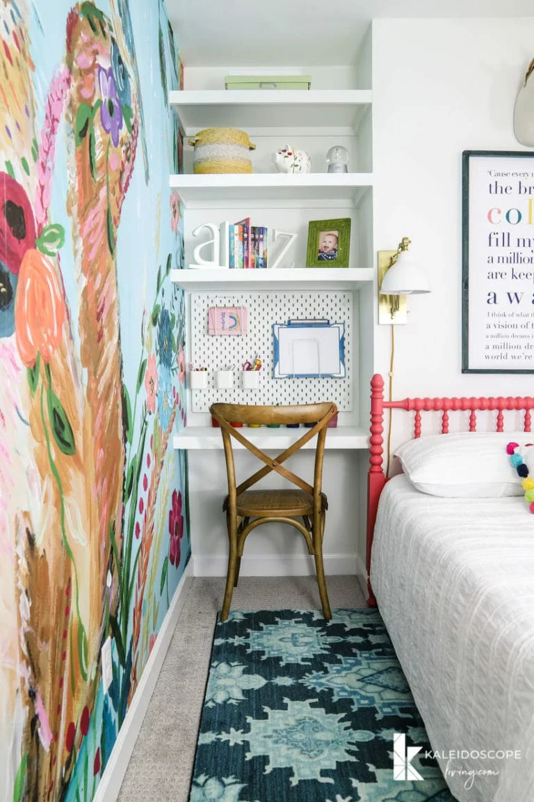 diy floating shelves and desk in corner of colorful girl's bedroom