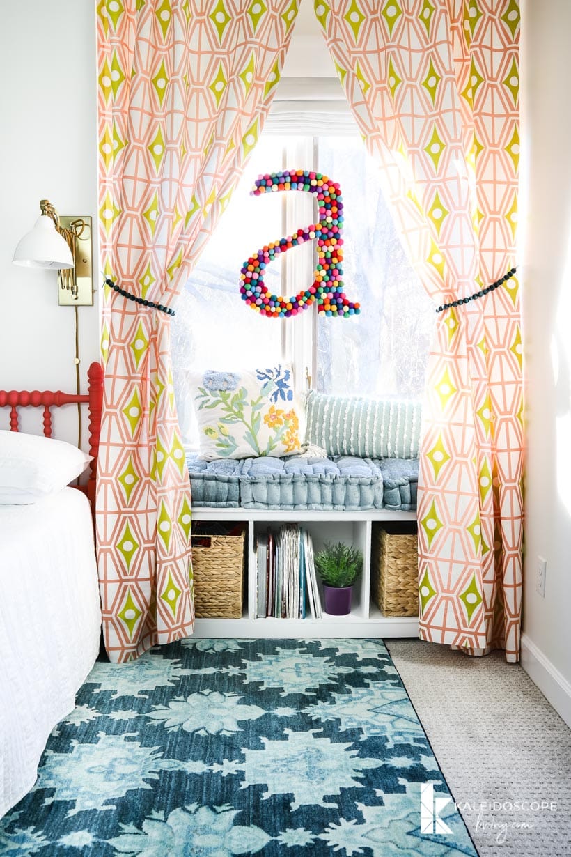 colorful girl's bedroom with window seat