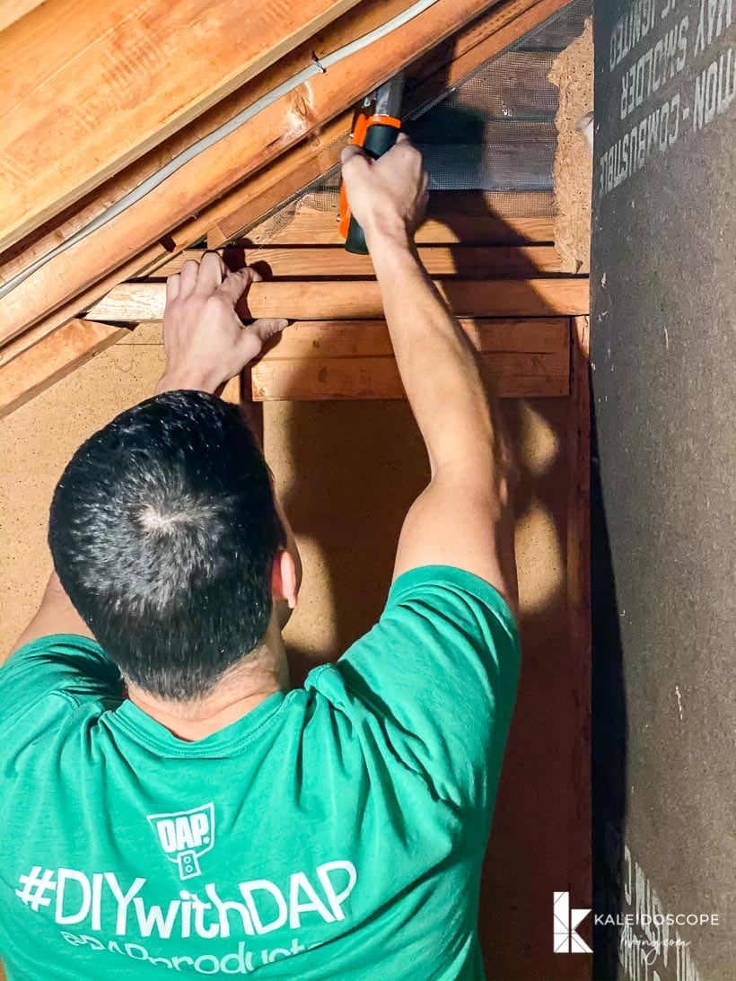 man doing work in attic