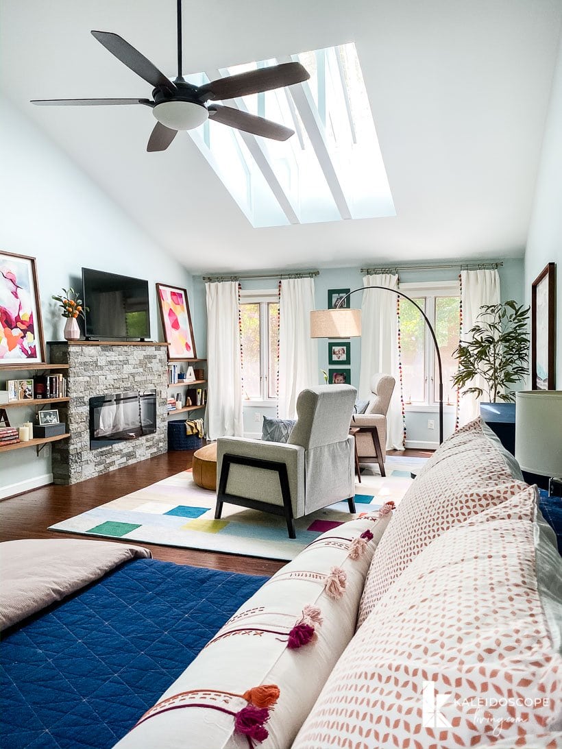 colorful master bedroom with sitting area and fireplace