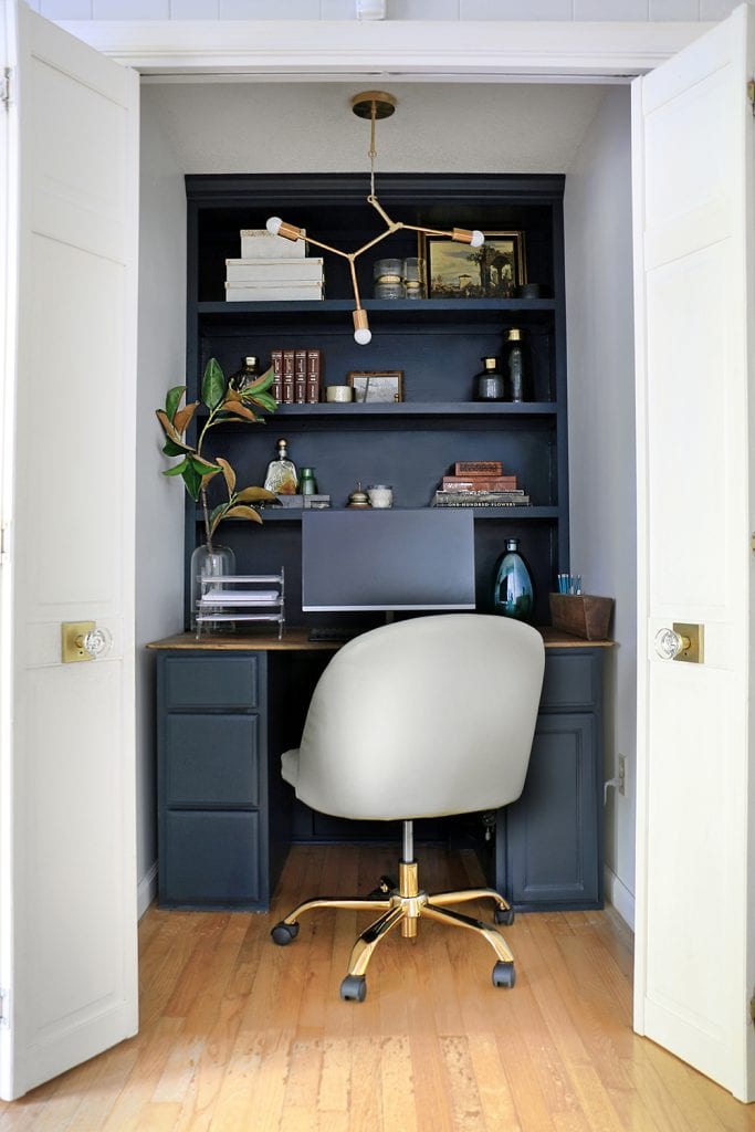 office in a closet with built in shelves