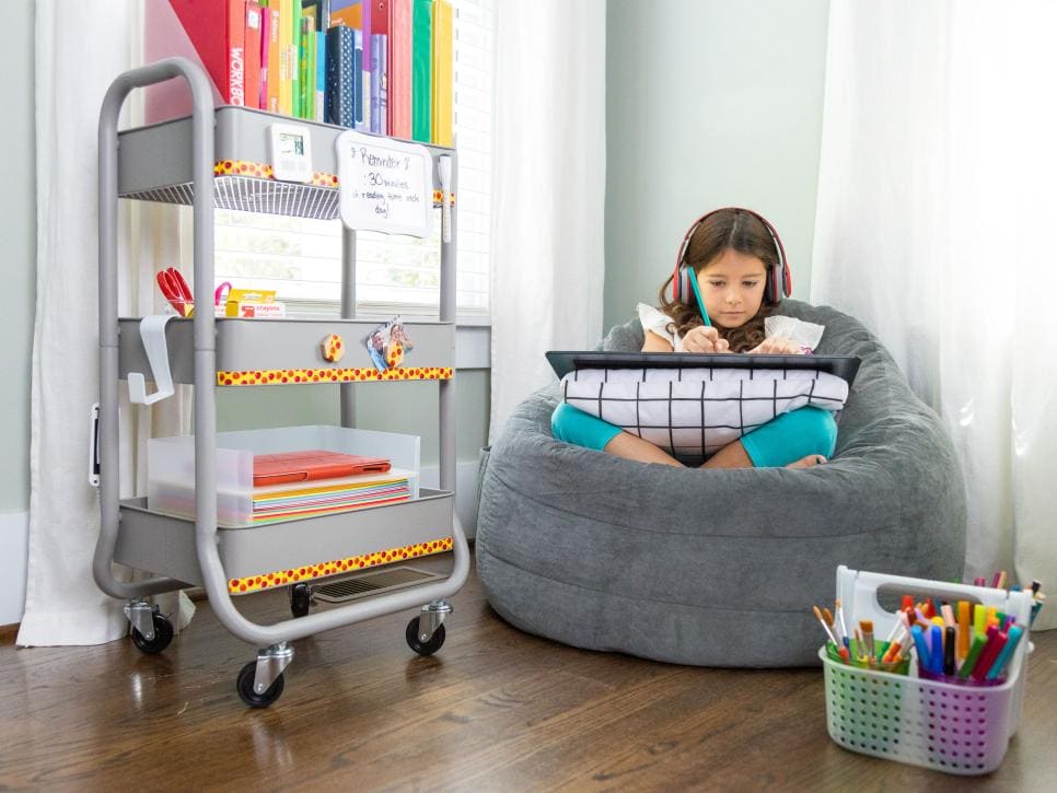 cart for school supplies and child working on bean bag chair