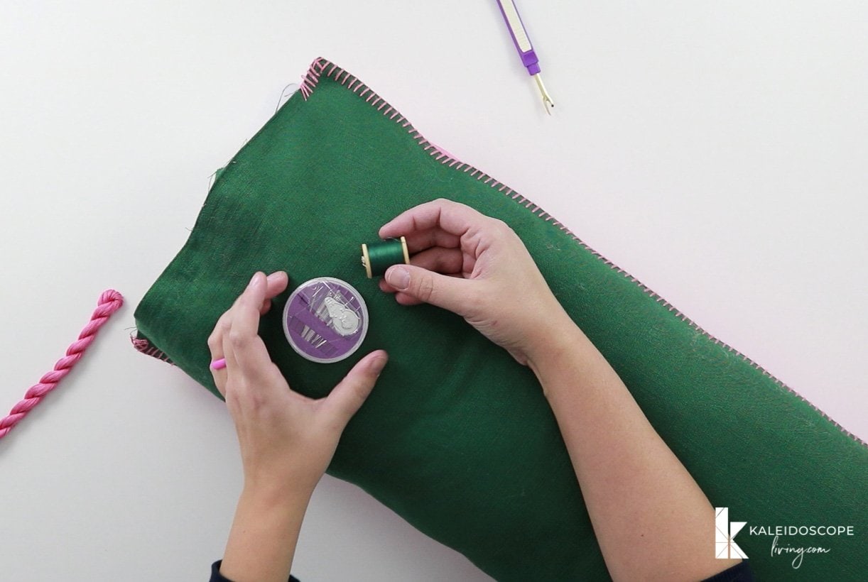 needle and thread on top of filled lumbar pillow