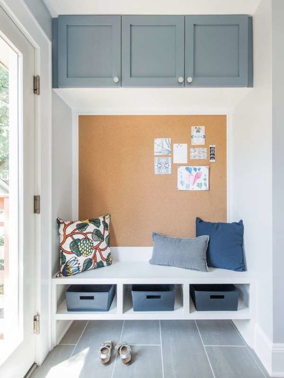 mudroom with high cabinets and huge bulletin board