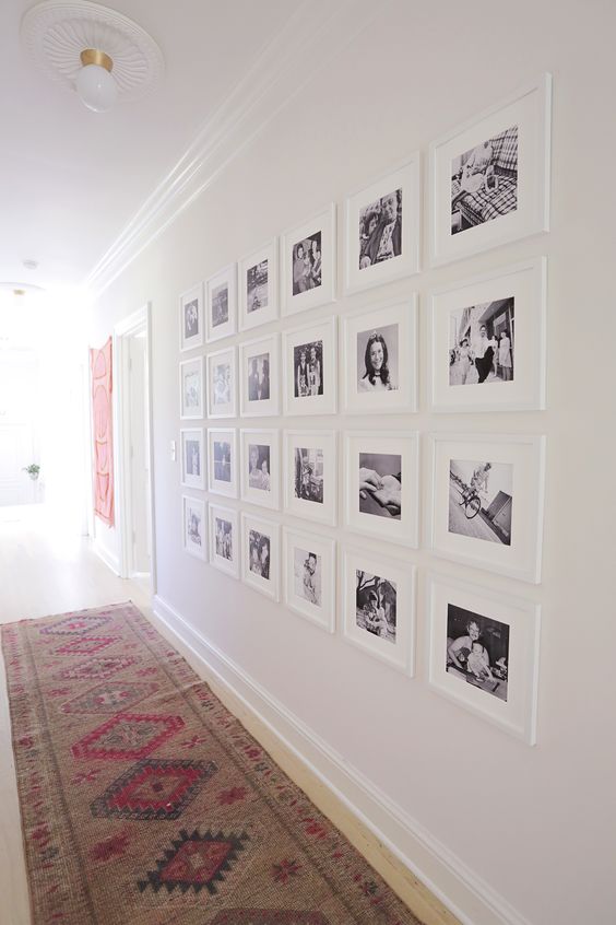 large grid photo gallery wall in hall