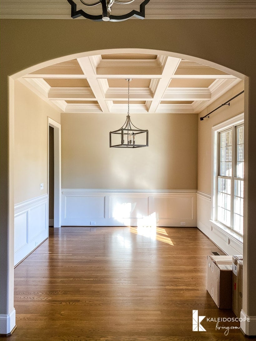 dining room with coffered ceiling and wainscoting