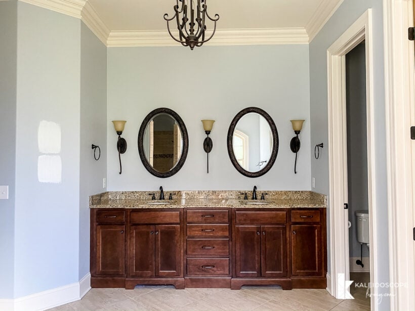 blue master bathroom with wood stained vanity