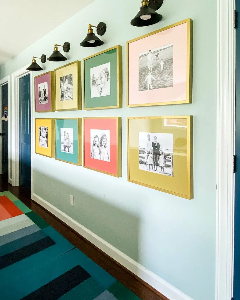 Colorful family photo gallery wall in hallway.