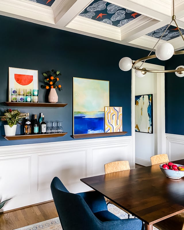 colorful art in navy dining room