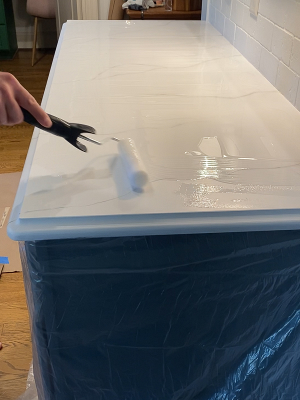 spreading epoxy resin topcoat on painted kitchen countertops
