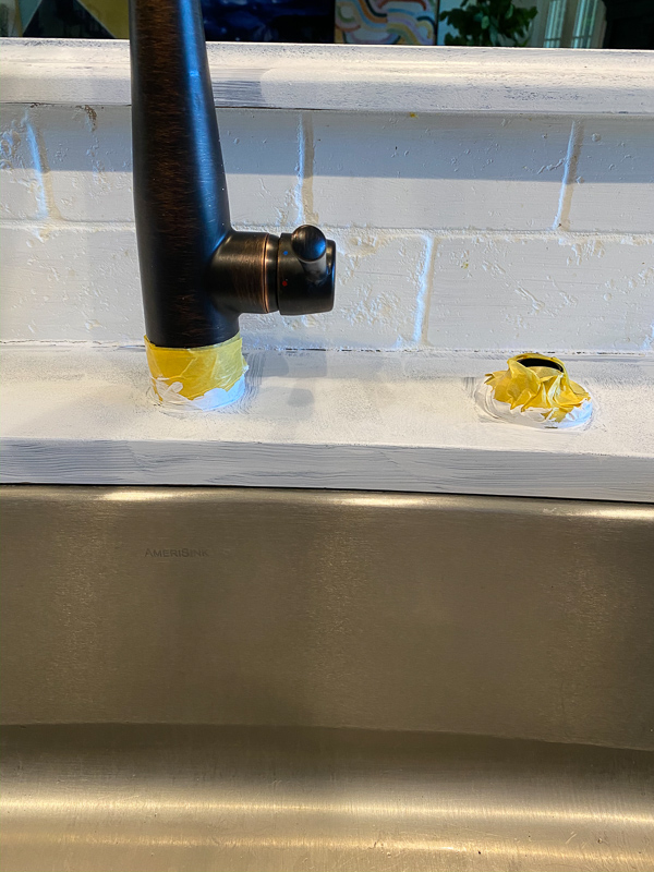 taped off kitchen faucet for painting counters