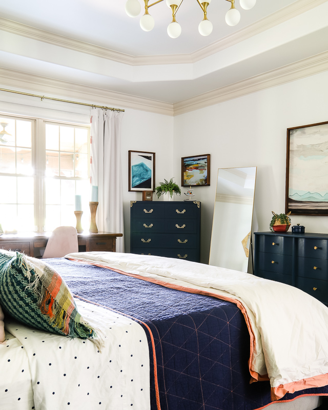 colorful master bedroom with navy furniture