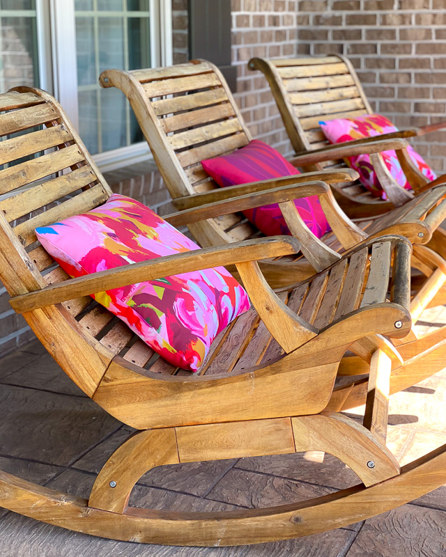 modern wood rockers with bright pink pillows