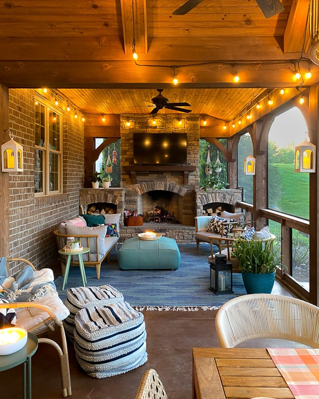 screened-in porch with fireplace and tv