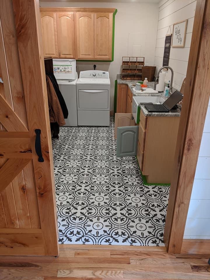 laundry room with wood trim and cabinets
