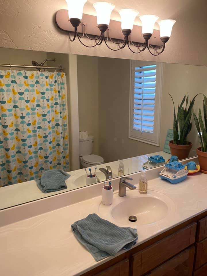outdated bathroom with wood cabinets