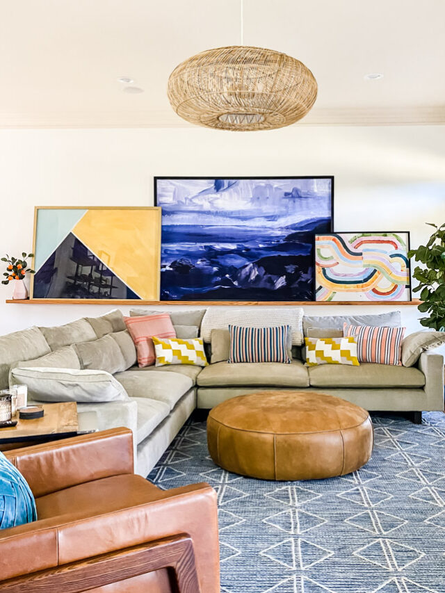 family room with beige couch and large wall art leaning on ledge
