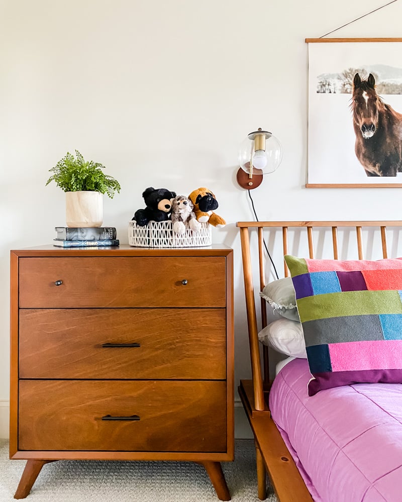 girls' room with purple bedding and midcentury modern furniture