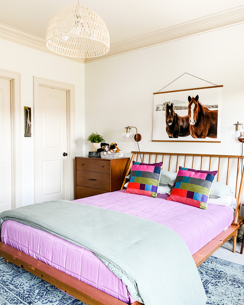 modern girls room with purple bedspread and horse art
