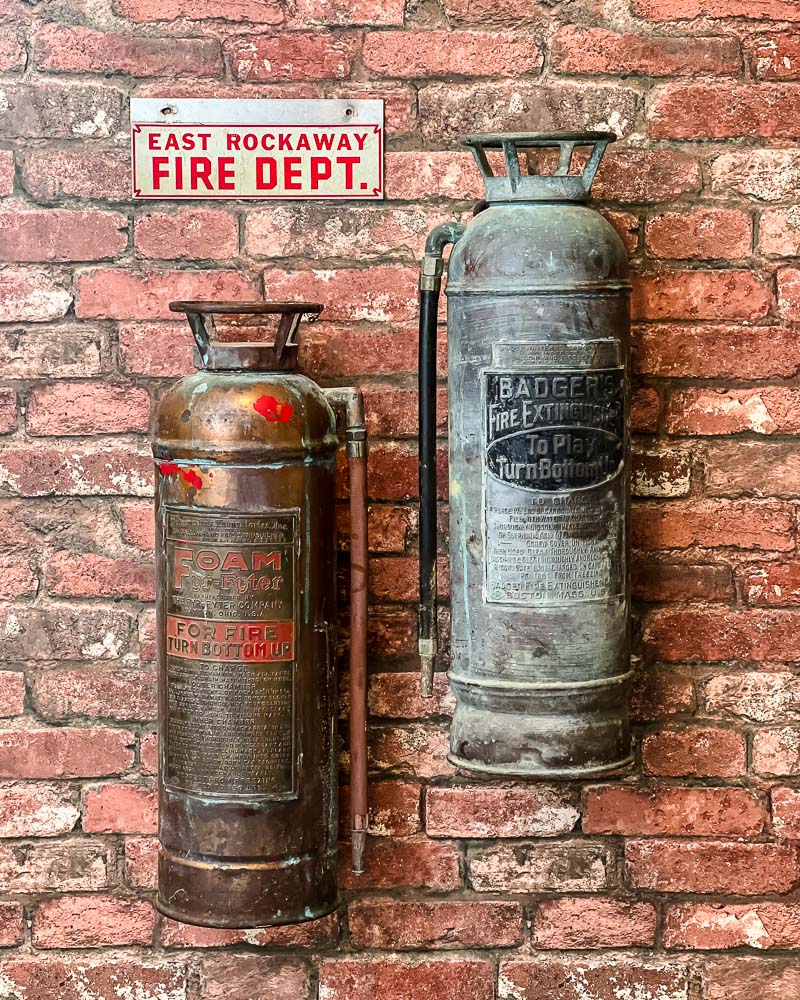 antique fire extinguishers on brick wallpaper