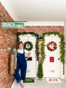 Tasha Agruso of Kaleidoscope Living standing in front of her daughters' bedroom doors that are decorated to look like apartment doors