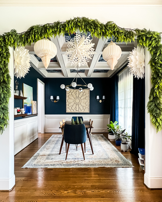 the best faux cedar garland hanging in doorway of dining room by Kaleidoscope Living