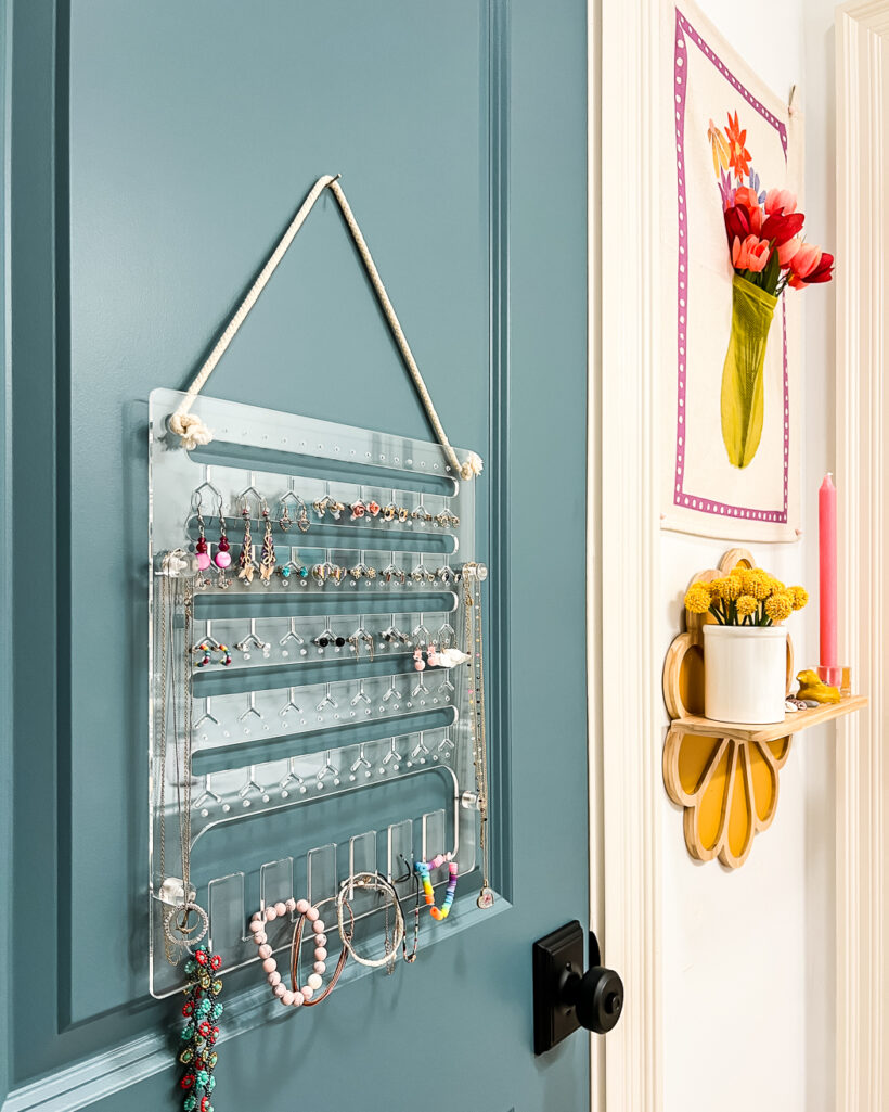 clear acrylic hanging jewelry organizer in girl's bathroom