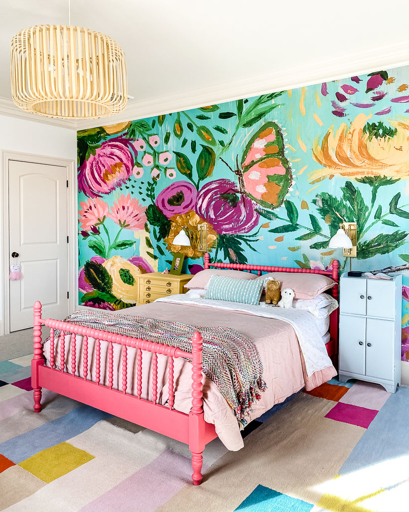 colorful girls bedroom with area rug on top of carpet and wall mural