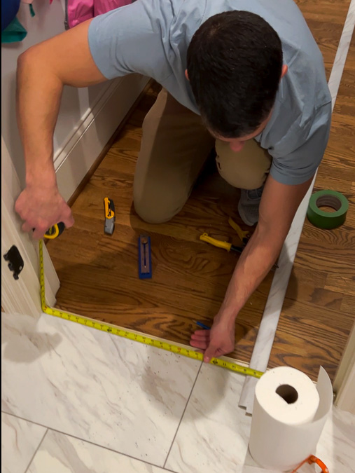 installing transition strip between floating tile floor and wood floor