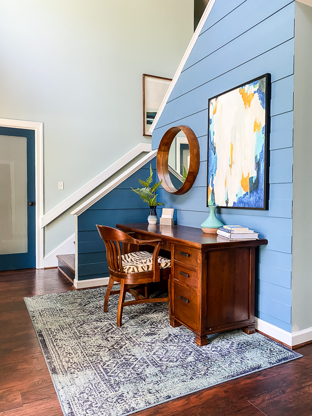 vibrant blue foyer with desk 