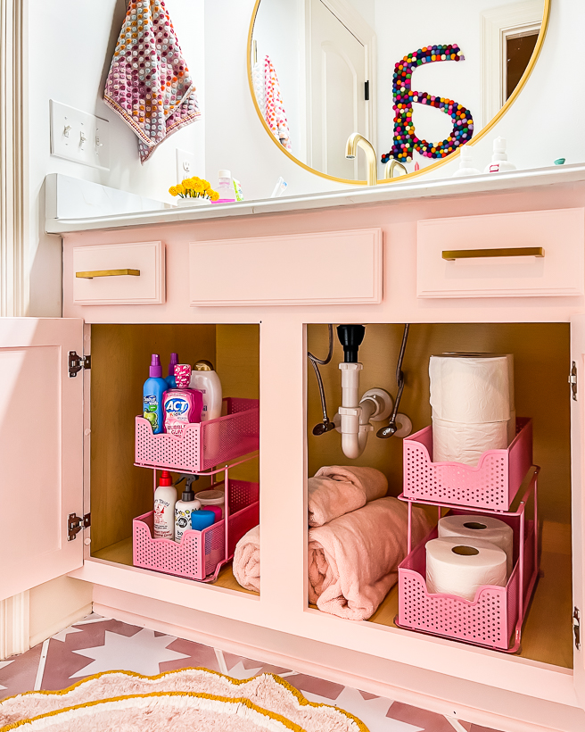 organized and decluttered bathroom cabinet in girl's bathroom