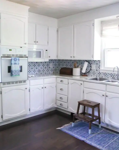 white kitchen with stenciled backsplash