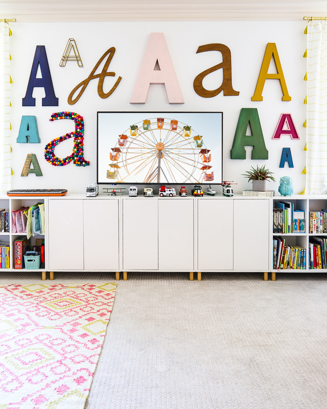 colorful playroom space with storage cabinets