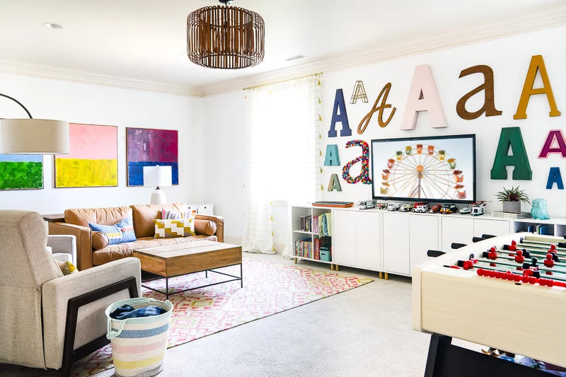 playroom ideas and tips-colorful playroom with storage and foosball table by Tasha Agruso of Kaleidoscope Living