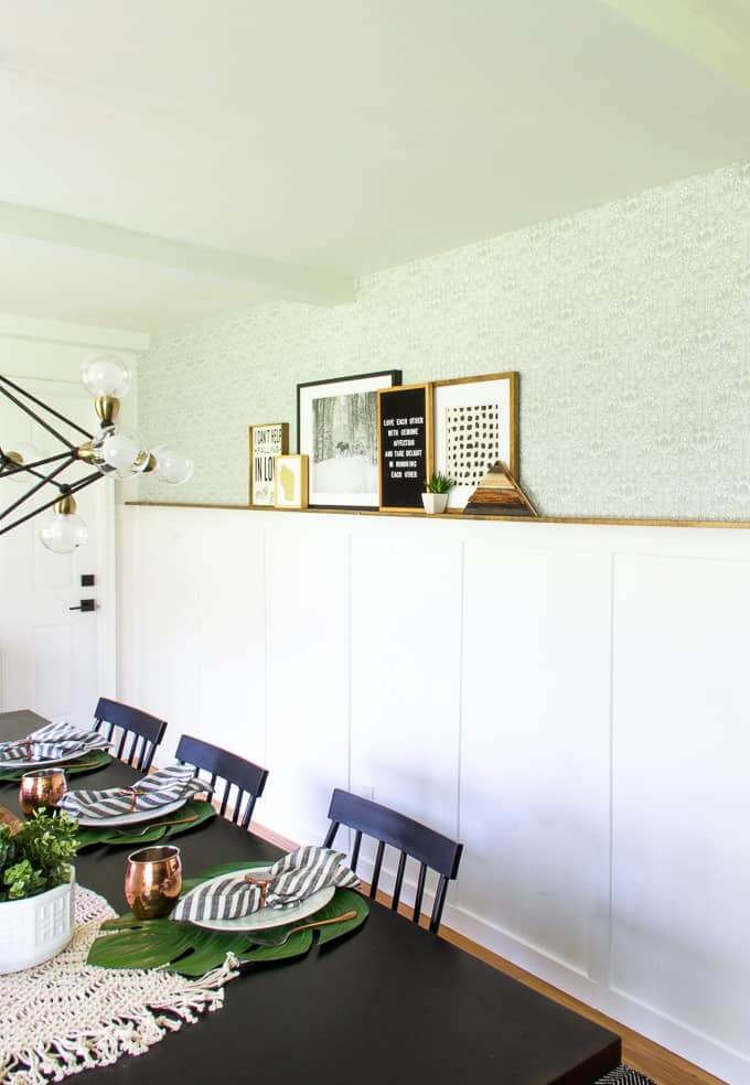 dining room with white board and batten with photo ledge and wallpaper