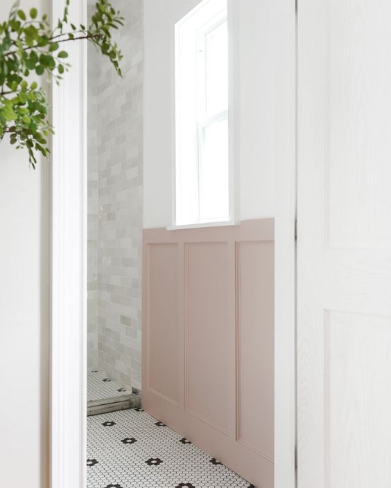pink board and batten wall in black and white bathroom
