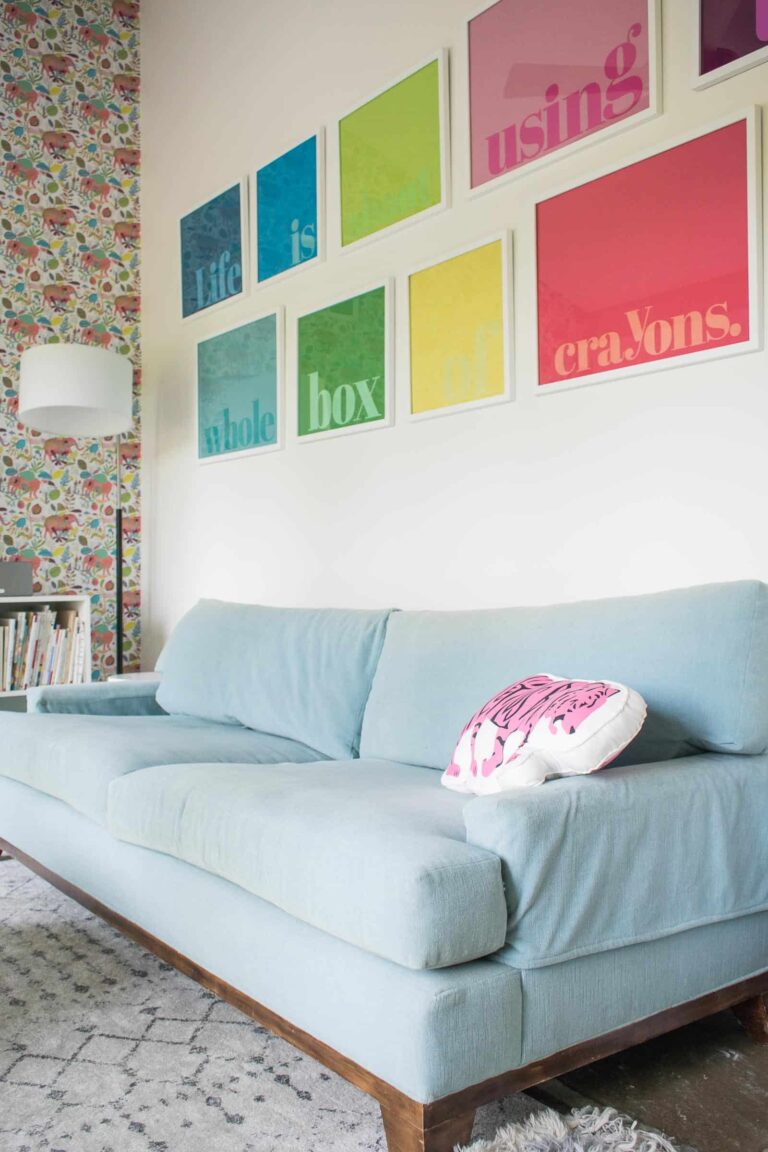 decoupaged rainbow wall art over light blue couch