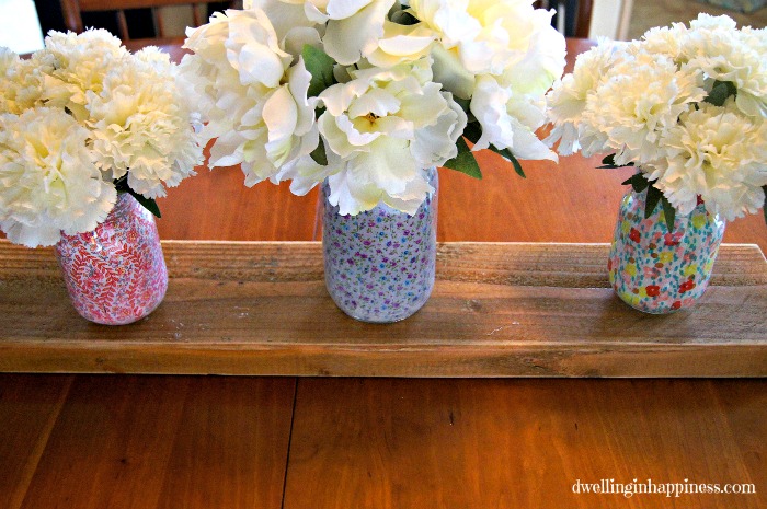 white flowers in jars decoupaged with colorful napkins