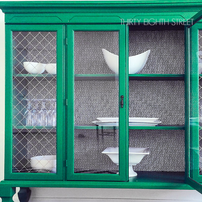 black and white print fabric backing in  green china cabinet