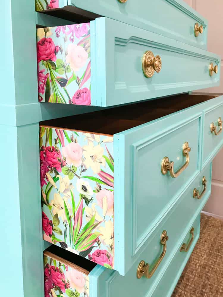turquoise dresser with flowered decoupage paper on sides of drawers