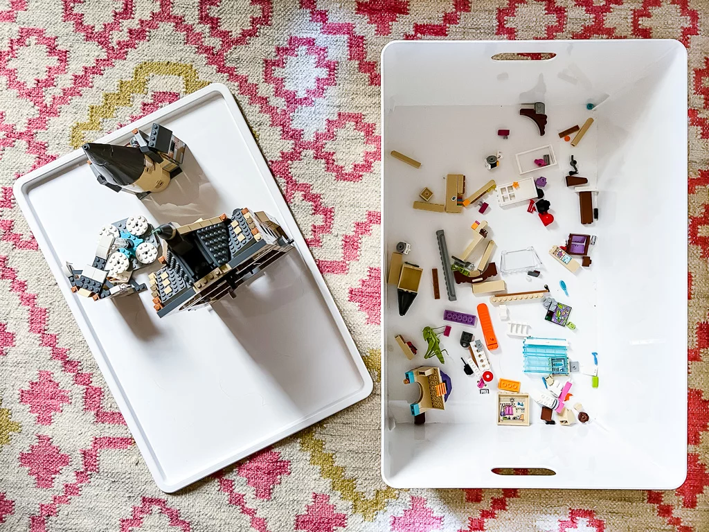 A plastic white bin and cover, as seen from above, are easy storage for LEGO and more. 