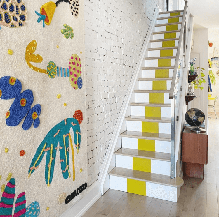 modern color blocked staircase with wood railing and plate glass