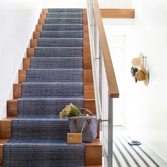 wood and metal stair railings with navy Annie Selke runner