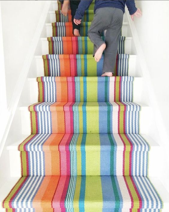 striped staircase runner over white stairs