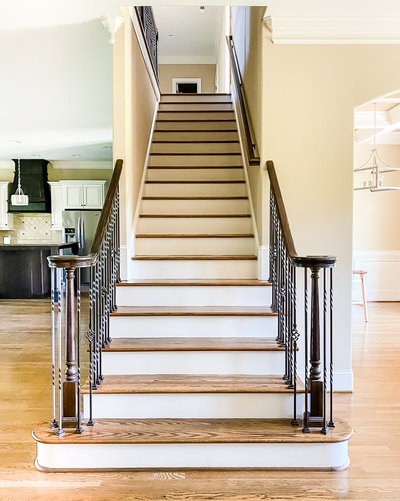 staircase with iron railing and no stair runner before DIY makeover