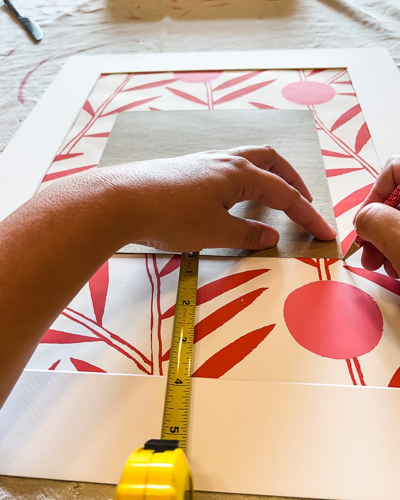 measuring for placement of family photos in frame