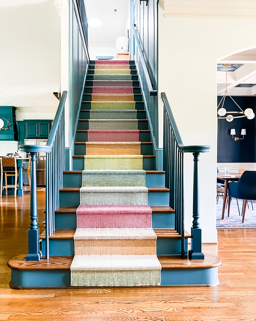 Blue and wood stairs create a focal point with the Annie Selke multicolor, bright staircase runner.