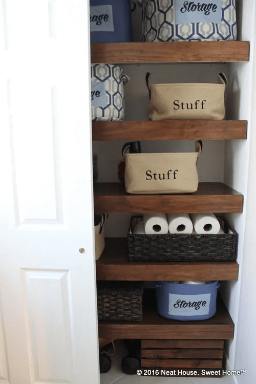 closet with wood over wire shelves and canvas tote bins