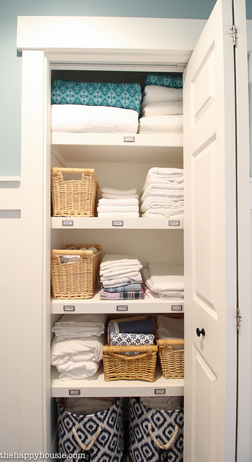 linen closet with labeled shelves
